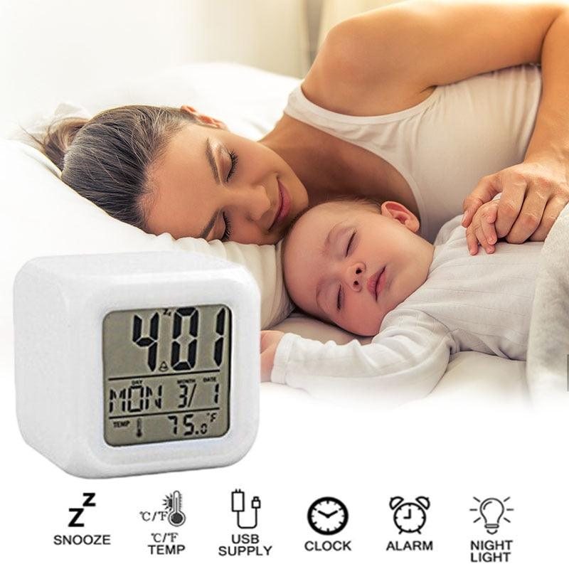 Woman and child lying in bed with a digital thermometer displaying temperature.