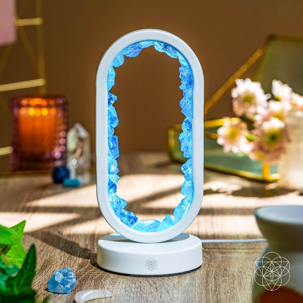 Decorative lamp with blue crystal-like design on a wooden surface. Manifest Success - Clear Quartz Lamp of Achievement