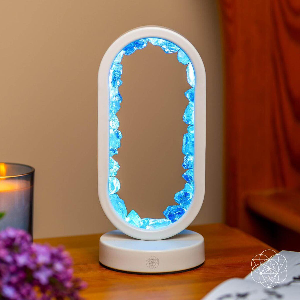Decorative lamp with blue interior on a wooden surface. Manifest Success - Clear Quartz Lamp of Achievement