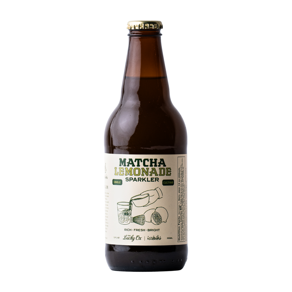 A bottle of Sparkler Matcha Lemonade Sparkler beer in an amber glass bottle with a cream-colored label and a gold crown cap, shown on a solid white background.