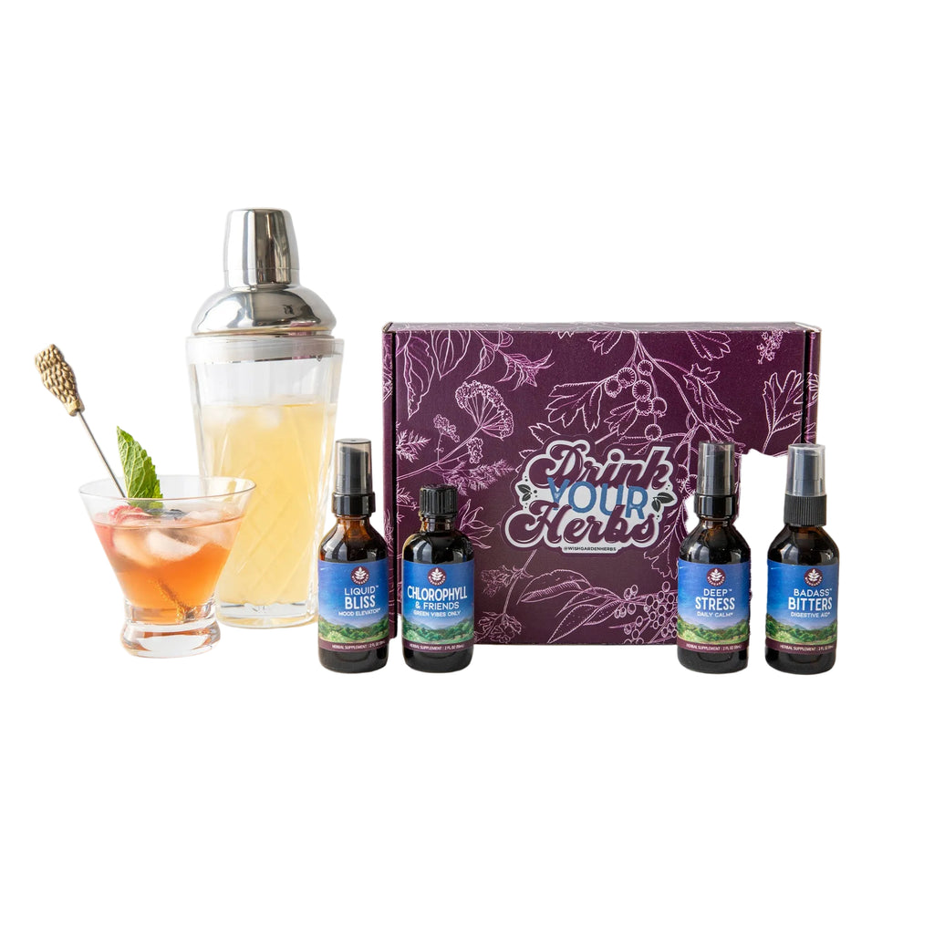 Herbal extract bottles with a cocktail and packaging on a white surface