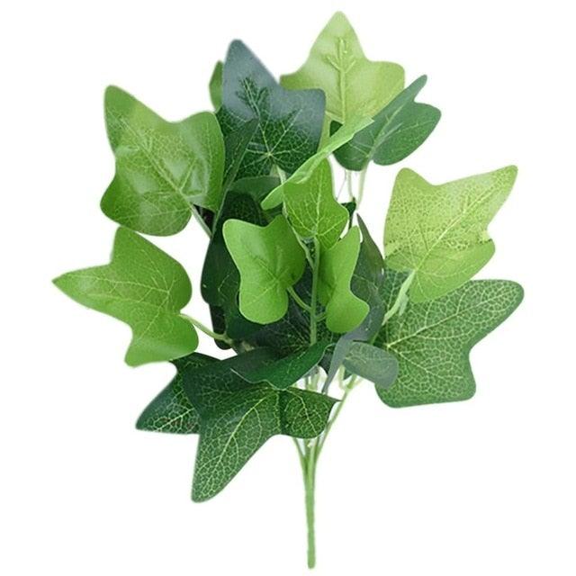 Artificial green leaf branch on a white background