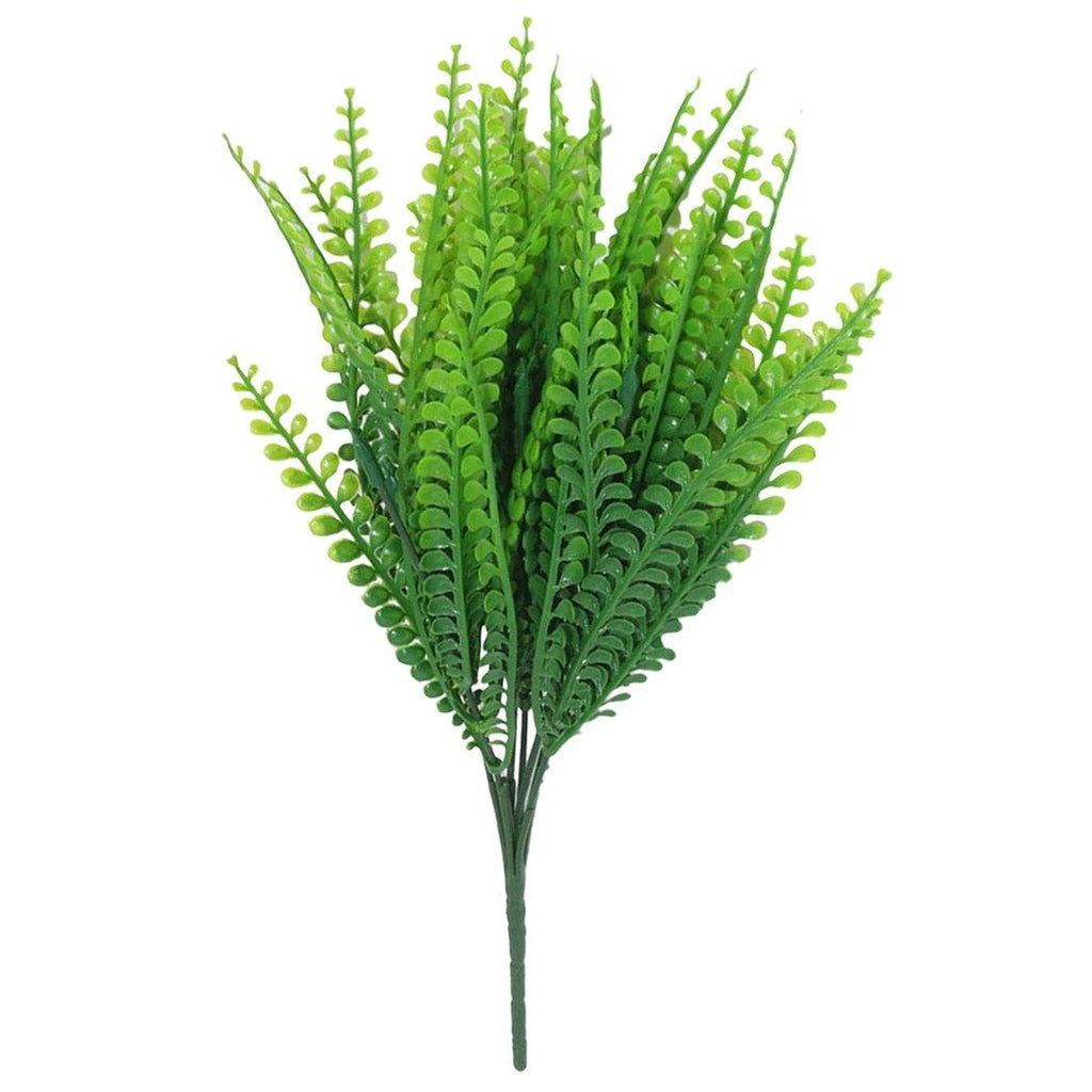 Artificial green fern plant on a white background