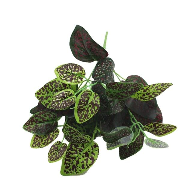 Artificial green and black leafy plant on a white background