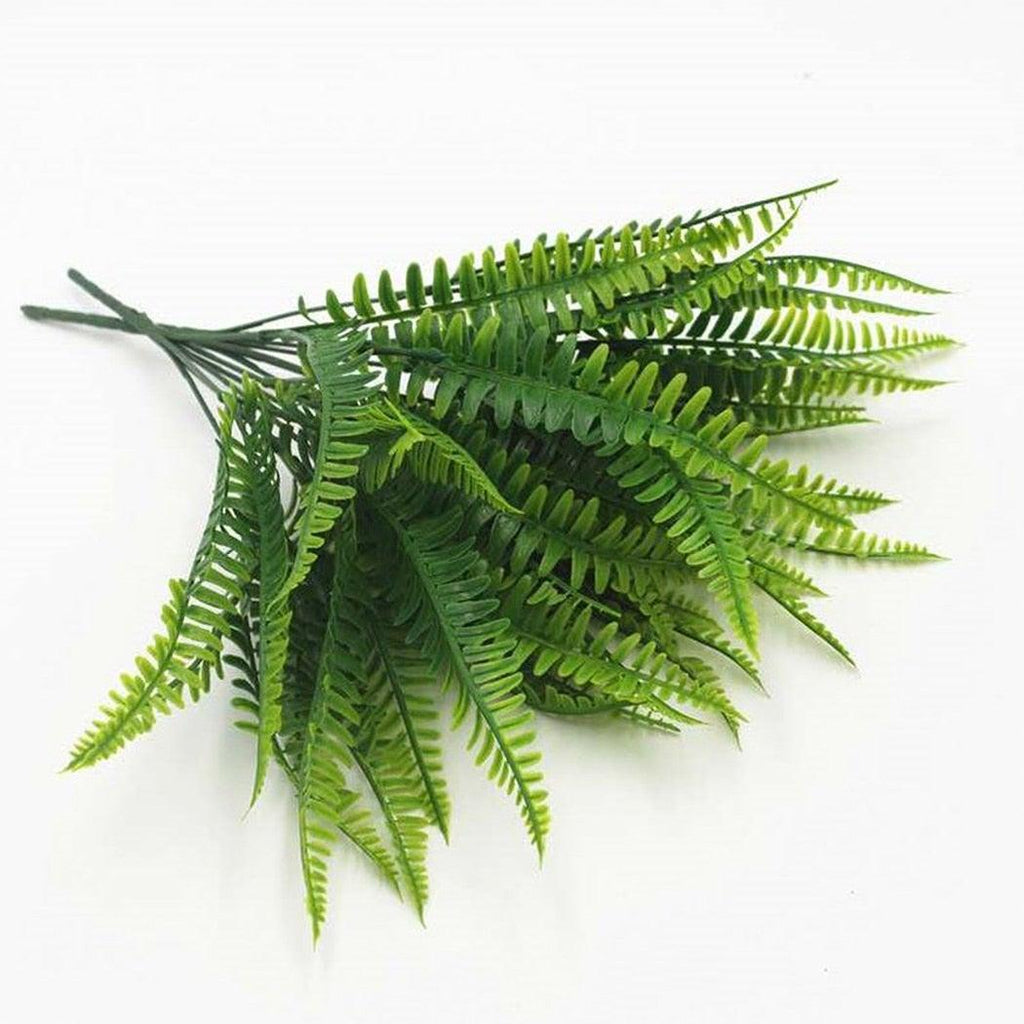 Artificial green fern leaves on a white background