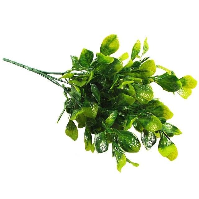 Artificial green leaves on a white background