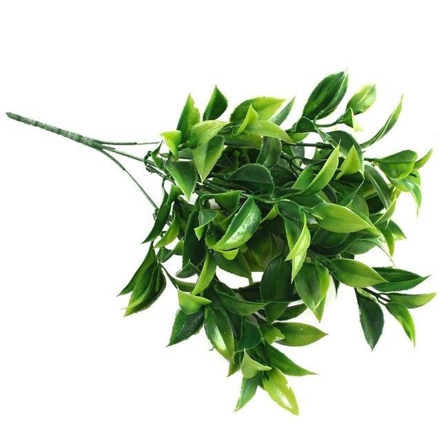 Artificial green leaves on a white background