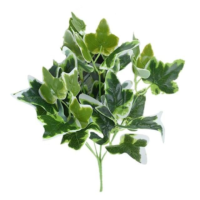 Artificial green leaf branch on a white background