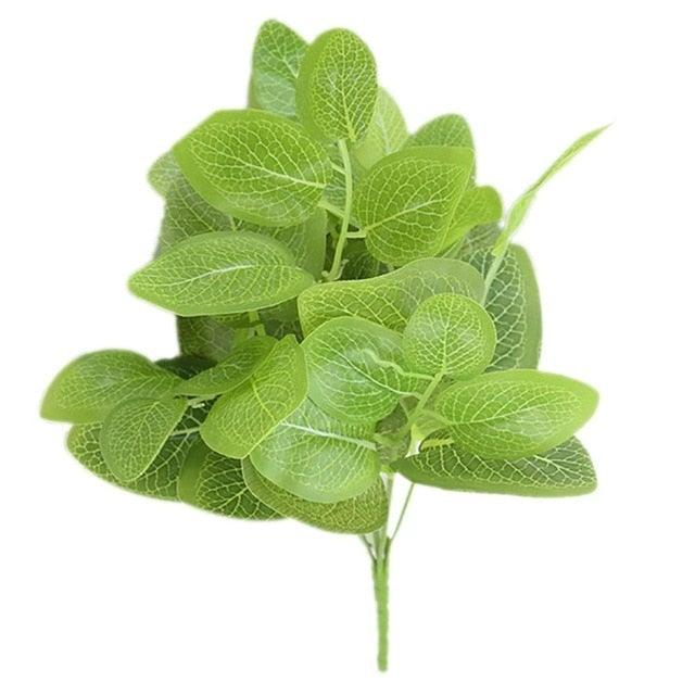Artificial green leaves on a white background