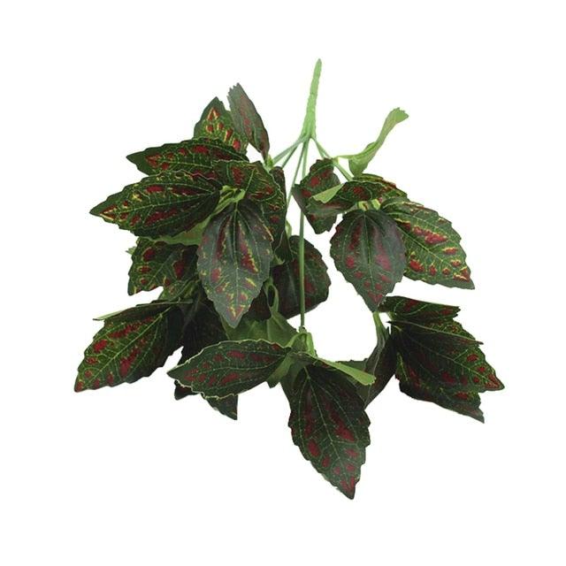 Artificial green leaf branch with red spots on a white background