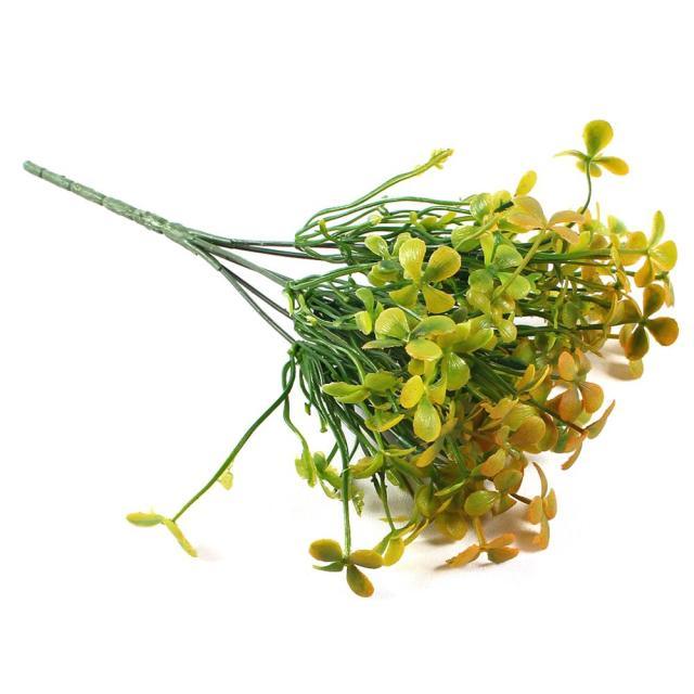 Bouquet of green and yellow artificial flowers on a white background