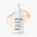 NIDA Alpha-Arbutin TXA Pure Tone Serum in a 50 ml white dropper bottle, set against a clean white background with a soft peach-colored cosmetic smear behind it.