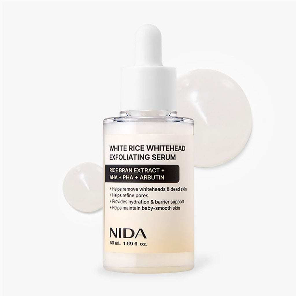 NIDA White Rice Whitehead Exfoliating Serum in a clear glass dropper bottle with a white cap, shown on a clean white background with two translucent droplet graphics behind it.