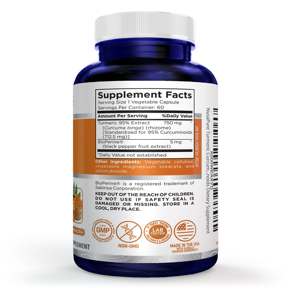 A blue plastic supplement bottle with a white cap, shown from the back with the label facing the camera. The label is white with black text and features a prominent orange band containing product details, along with several certification logos at the bottom. Tumeric Supplement. GMP stamped, NON-GMO, LAB TESTED, MADE IN THE USA.
