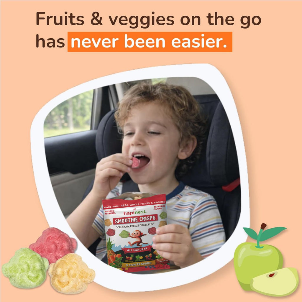 A child in a car seat eating a piece of fruit while holding a bag of Happiness Smoothie Crisps. The image is set on a peach background with promotional text at the top and illustrations of colorful gummy fruits at the bottom. Tree Nut-Free, Peanut-Free, Egg-Free, Dairy-Free, Wheat-Free, Fish-Free, Sesame-Free, Celery-Free, Lupin-Free, Soy-Free, Shell-Fish Free, Gluten-Free, Mustard-Free, Sulphites-Free. Made with 13 fruits and veggies, source of 12 vitamins and minerals.