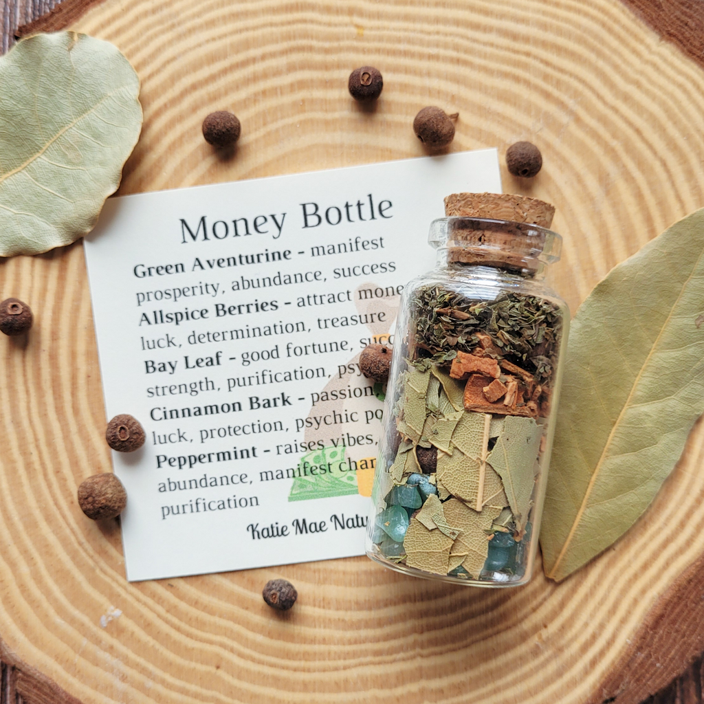 Money Bottle manifestation spell jar by Katie Mae Naturals with green aventurine, allspice berries, bay leaf, cinnamon bark and peppermint for prosperity, abundance, success, good fortune and positive energy.