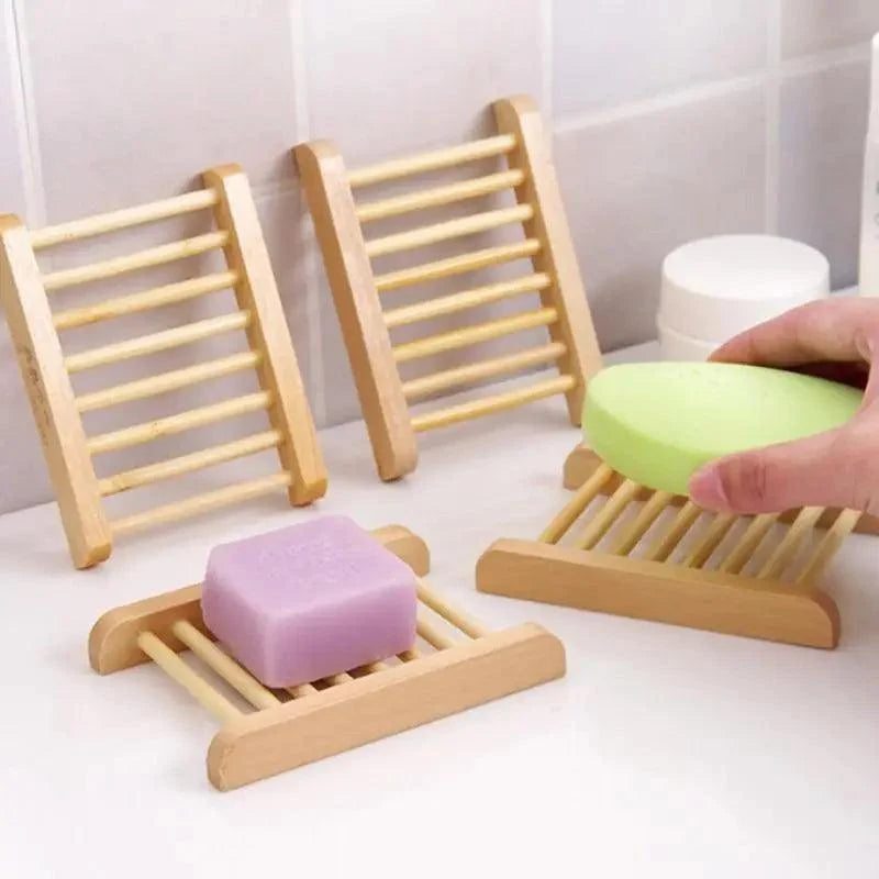 Bamboo soap holders with soap bars on a white surface