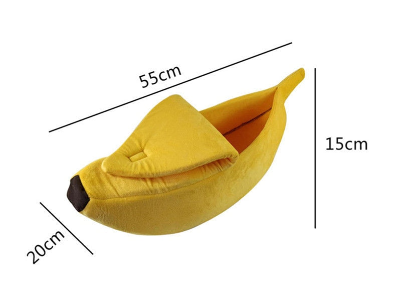 Yellow banana-shaped plush pet bed with size measurements, measuring 55 cm long, 20 cm wide, and 15 cm high, designed for cats, kittens, puppies, and small dogs.