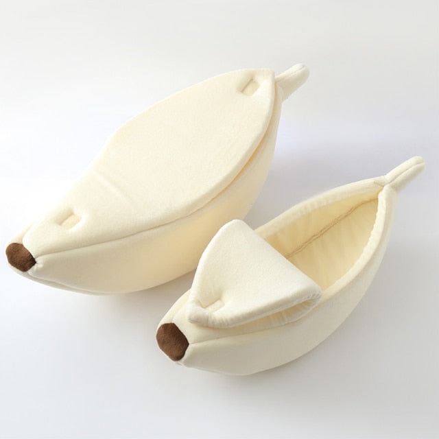 White banana-shaped plush pet bed with a cozy cave design for cats, kittens, puppies, and small dogs on a white background.