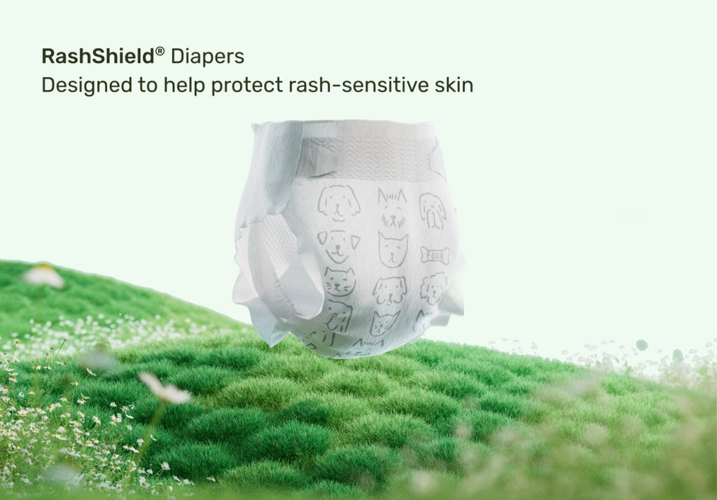 Parasol RashShield® disposable baby diaper displayed on a lush green grassy field beneath the text "Designed to help protect rash-sensitive skin," highlighting breathable comfort, gentle skin protection, premium materials, and everyday diaper care for babies.