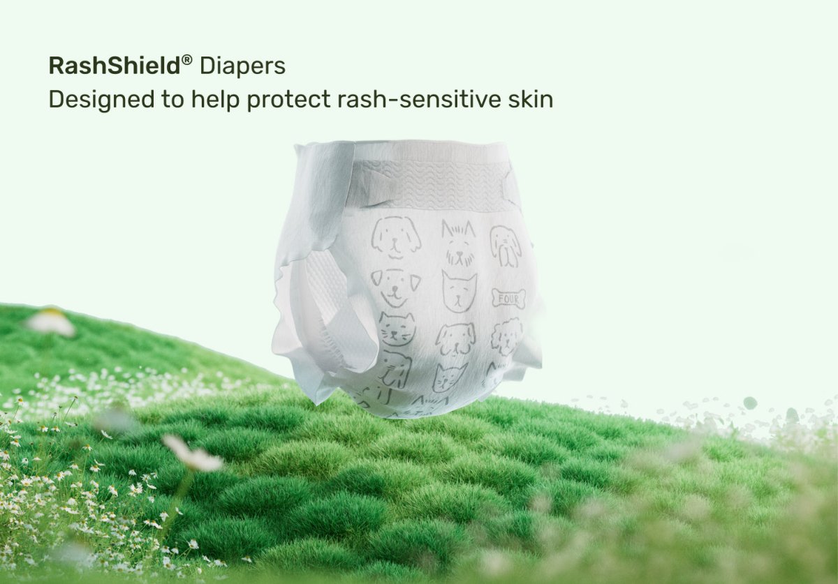 Parasol RashShield® disposable baby diaper displayed on a lush green grassy field beneath the text "Designed to help protect rash-sensitive skin," highlighting breathable comfort, gentle skin protection, premium materials, and everyday diaper care for babies.