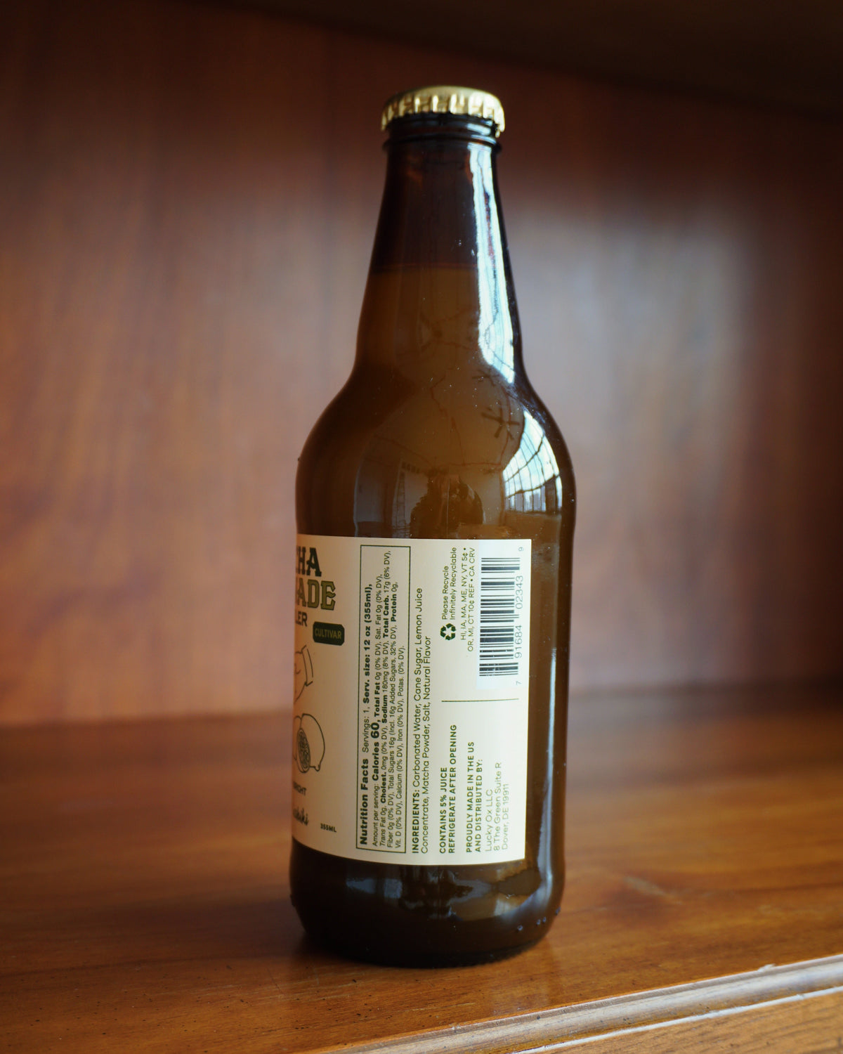 Brown bottle with a label on a wooden surface