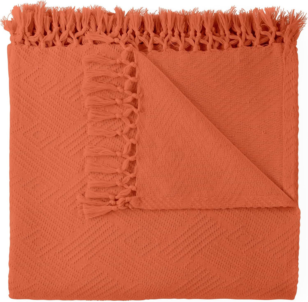 Orange throw blanket with frayed edges on a white background. Diamond Jacquard Throw Rust