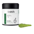 A jar of Isshiki Samidori Ceremonial Grade Matcha green tea powder with a black lid and white label, shown on a white background with a green powder smear.