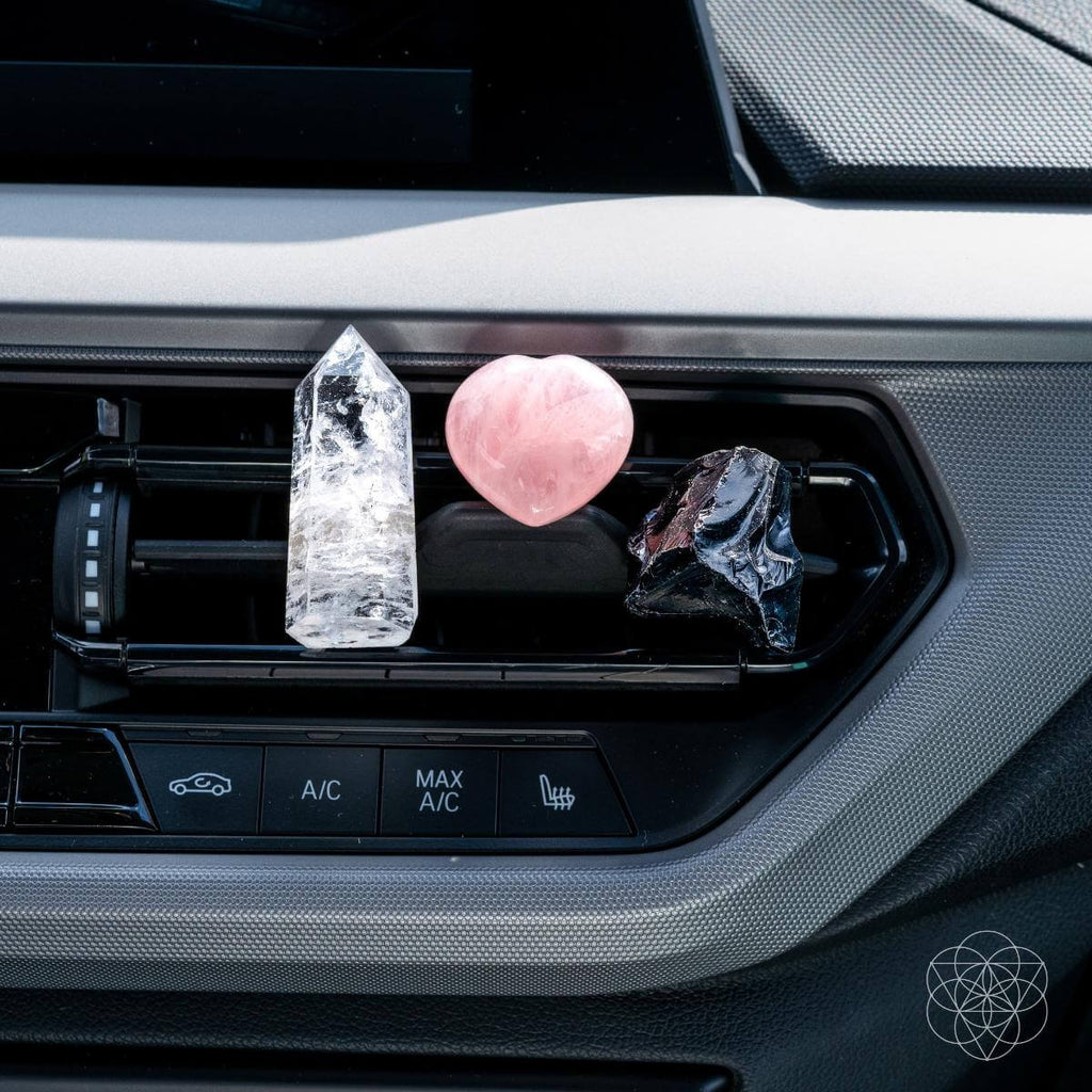 Decorative crystals on a car air vent with visible brand logo. Spiritual GPS Guardian Car Vent Crystal Clip Kit | Protection Crystals for Safe Travel & Positive Energy