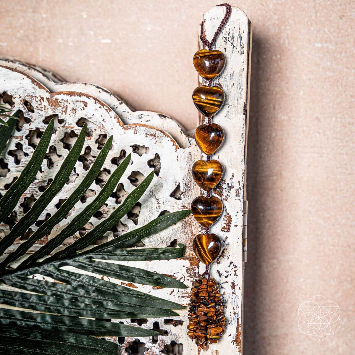 Decorative wall hanging with heart-shaped beads and a textured frame on a beige background Protection Tassel with Tiger's Eye Crystal for Protection, Positive Energy & Car Charm