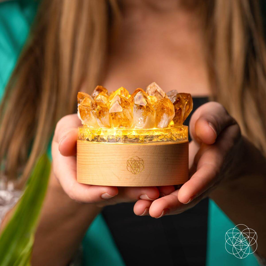 Person holding a wooden box with crystal-like objects inside, illuminated from within. Turn My Life to Gold - Midas Citrine Lamp