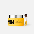 Vitamin C clay mask with a brush on a white background