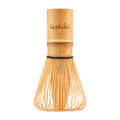 A traditional Japanese bamboo whisk (chashaku) with the brand name 'isshiki' engraved on the wooden handle, set against a solid white background.